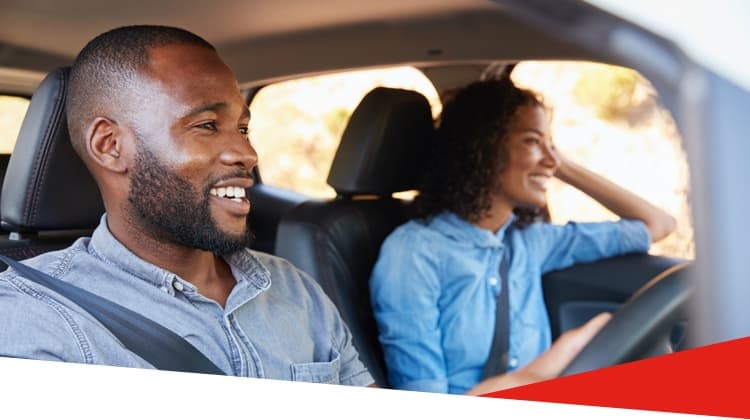 Happy couple driving a car