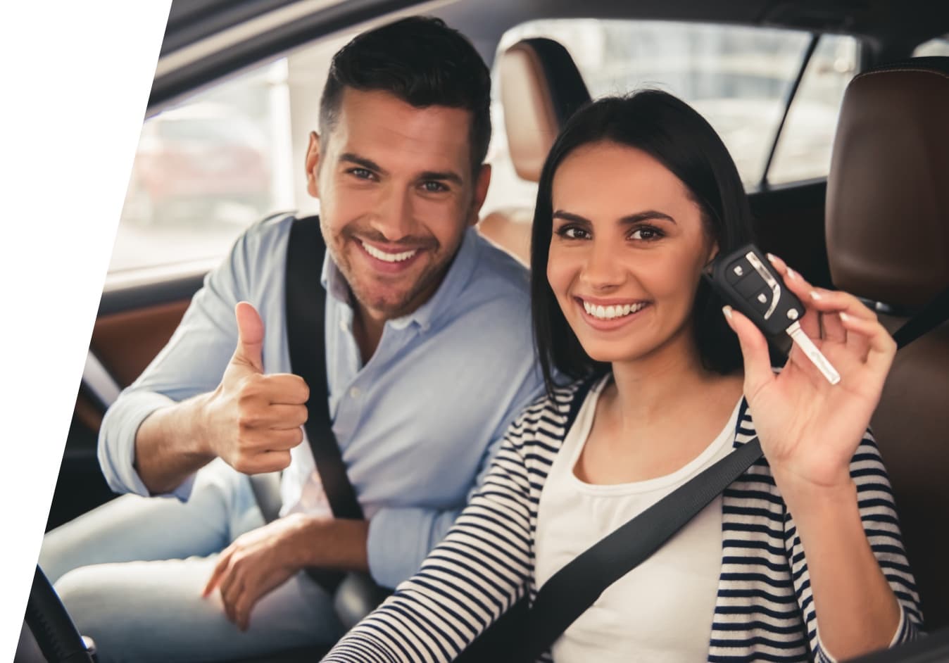 Happy couple driving a car